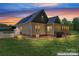 Dusk view of a home featuring solar panels and a screened-in porch at 520 Steeple Chase Trl, Salisbury, NC 28144