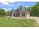 Beautiful home exterior with stone accents and a well-manicured lawn at 520 Steeple Chase Trl, Salisbury, NC 28144