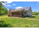 Exterior of home with a screened porch and well-maintained lawn at 520 Steeple Chase Trl, Salisbury, NC 28144
