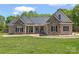 Inviting one story home featuring a well-manicured lawn and beautiful stone and vinyl siding accents at 520 Steeple Chase Trl, Salisbury, NC 28144