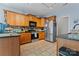 Cozy kitchen featuring wooden cabinets, stainless steel appliances, and tiled flooring at 520 Steeple Chase Trl, Salisbury, NC 28144