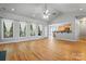 Open living space with hardwood floors, big windows, and easy access to kitchen at 520 Steeple Chase Trl, Salisbury, NC 28144