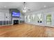 Bright living room with hardwood floors, a fireplace, built-in shelves, and large windows at 520 Steeple Chase Trl, Salisbury, NC 28144