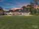 Expansive backyard featuring a screened porch, pergola, and lush green lawn at 5933 Legacy Ln, Kannapolis, NC 28081