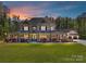 Magnificent two-story stone home with sprawling front porch and manicured lawn at 5933 Legacy Ln, Kannapolis, NC 28081