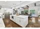 Open-concept kitchen with island seating, stainless steel appliances, and hardwood floors at 5933 Legacy Ln, Kannapolis, NC 28081