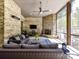 Cozy screened porch with an inviting seating area and a stone fireplace at 5933 Legacy Ln, Kannapolis, NC 28081