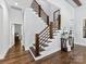 Elegant staircase featuring hardwood steps, white risers, and modern wood railings at 5933 Legacy Ln, Kannapolis, NC 28081