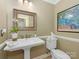Traditional bathroom with pedestal sink, unique mirror, and a colorful art print at 5935 Winburn Ln, Charlotte, NC 28226