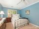 Comfortable bedroom with shuttered window and ceiling fan at 5935 Winburn Ln, Charlotte, NC 28226
