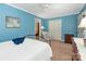 Light filled bedroom with white furniture and blue accent wall at 5935 Winburn Ln, Charlotte, NC 28226