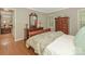 A charming bedroom featuring a sleigh bed, hardwood floors, and natural light from the windows at 5935 Winburn Ln, Charlotte, NC 28226