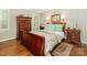 This primary bedroom features hardwood floors, a large bed, and traditional furnishings at 5935 Winburn Ln, Charlotte, NC 28226