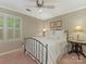 Inviting bedroom with neutral walls, white trim, ceiling fan and a bright shuttered window at 5935 Winburn Ln, Charlotte, NC 28226