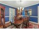 Elegant dining room with blue walls, classic chandelier, and traditional wood furniture at 5935 Winburn Ln, Charlotte, NC 28226
