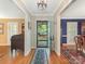 Bright foyer with hardwood flooring, showcasing a view of the front yard through an open door at 5935 Winburn Ln, Charlotte, NC 28226