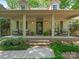 Inviting front porch featuring comfortable seating, decorative plants, and a welcoming entrance at 5935 Winburn Ln, Charlotte, NC 28226