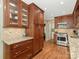 A modern kitchen with hardwood floors, granite countertops, and stainless steel appliances offers style and function at 5935 Winburn Ln, Charlotte, NC 28226