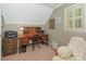Home office with a traditional wood desk, chair, and a window with bright natural light at 5935 Winburn Ln, Charlotte, NC 28226