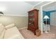 Inviting sitting room with a comfortable couch, bookshelf, and cozy decor at 5935 Winburn Ln, Charlotte, NC 28226