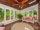 This bright sunroom boasts natural light, a wood ceiling, and lush green views at 5935 Winburn Ln, Charlotte, NC 28226