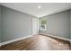 This bedroom has wood-look floors, white trim, and a sunny window, ready for personalization at 606 & 608 Hampton Rd, Lancaster, SC 29720