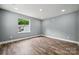 This cozy bedroom has wood-look floors and a bright window, offering a comfortable retreat at 606 & 608 Hampton Rd, Lancaster, SC 29720