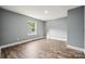 Bright bedroom features a large window, neutral paint and gorgeous floors at 606 & 608 Hampton Rd, Lancaster, SC 29720