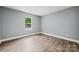This cozy bedroom has wood-look floors and a bright window, offering a comfortable retreat at 606 & 608 Hampton Rd, Lancaster, SC 29720