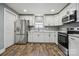 Modern kitchen features stainless appliances, bright white cabinets and updated countertops at 606 & 608 Hampton Rd, Lancaster, SC 29720