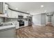 Modern kitchen has stainless steel appliances, including a refrigerator and oven, with stylish wood-look flooring at 606 & 608 Hampton Rd, Lancaster, SC 29720