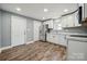 Modern kitchen boasts stainless appliances, bright white cabinets and updated countertops at 606 & 608 Hampton Rd, Lancaster, SC 29720