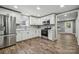 This modern kitchen features stainless appliances, white cabinets and updated countertops at 606 & 608 Hampton Rd, Lancaster, SC 29720