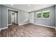 Bright living room with wood-look floors, multiple windows, and white trim offers a clean, modern feel at 606 & 608 Hampton Rd, Lancaster, SC 29720