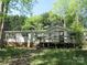 Charming home with a front deck, surrounded by lush greenery and trees at 6293 Karen Dr, Claremont, NC 28610