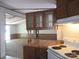 Functional kitchen boasting wood cabinets, ample counter space, and an electric range, blending practicality with a cozy feel at 6293 Karen Dr, Claremont, NC 28610