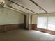 Cozy living room with natural light, enhanced by ceiling fan and neutral flooring and wall paneling at 6293 Karen Dr, Claremont, NC 28610