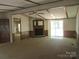 Spacious living room with a fireplace and sliding doors, ideal for relaxation and gatherings at 6293 Karen Dr, Claremont, NC 28610