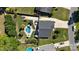 Aerial view of a backyard featuring a kidney shaped pool, patio, outdoor fireplace, and lush landscaping at 7018 Huntsmaster Dr, Charlotte, NC 28277
