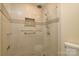 Bright renovated shower with floor to ceiling tile, glass door, and rainfall shower head at 7018 Huntsmaster Dr, Charlotte, NC 28277