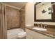 Bathroom featuring tub-shower combo with decorative tile and granite vanity at 7018 Huntsmaster Dr, Charlotte, NC 28277