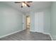 Bedroom with light colored walls, wood-look floor, and a double door closet at 7018 Huntsmaster Dr, Charlotte, NC 28277
