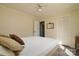 Bright bedroom features neutral walls, ceiling fan, plush pillows, and closet at 7018 Huntsmaster Dr, Charlotte, NC 28277