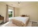 Cozy bedroom features carpet, a ceiling fan, and a large window with plenty of natural light at 7018 Huntsmaster Dr, Charlotte, NC 28277