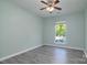Bedroom with ceiling fan, a window overlooking pool, and light colored walls at 7018 Huntsmaster Dr, Charlotte, NC 28277