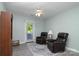 Bonus room featuring a pair of recliners, ceiling fan, and exterior access at 7018 Huntsmaster Dr, Charlotte, NC 28277