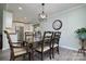 Charming dining room features an open layout, stylish light fixture, and neutral wall color at 7018 Huntsmaster Dr, Charlotte, NC 28277