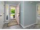 Welcoming entryway with a pink door and grey flooring, leading to the living areas at 7018 Huntsmaster Dr, Charlotte, NC 28277