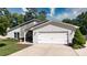 Charming home with stone accents, a well-manicured lawn, and a two-car garage at 7018 Huntsmaster Dr, Charlotte, NC 28277