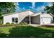 The home has a beautiful lawn, attractive landscaping, stone accents, and a two-car garage at 7018 Huntsmaster Dr, Charlotte, NC 28277